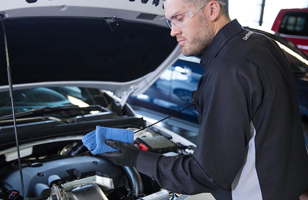 Chevrolet Service specialist changing oil on a Chevrolet Vehicle